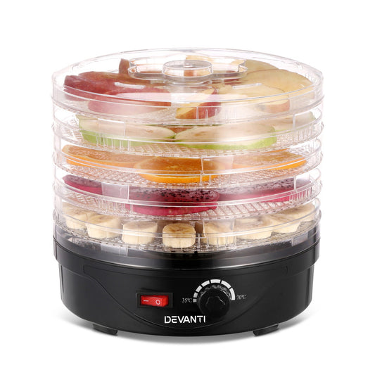 Electric food dehydrator with clear trays, filled with sliced fruits, temperature dial visible