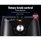 Close-up of black air fryer control panel with rotary knob, heating indicator, and timer setting.