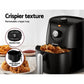 Black air fryer with fried chicken, highlighting removable crisper tray and food-grade basket