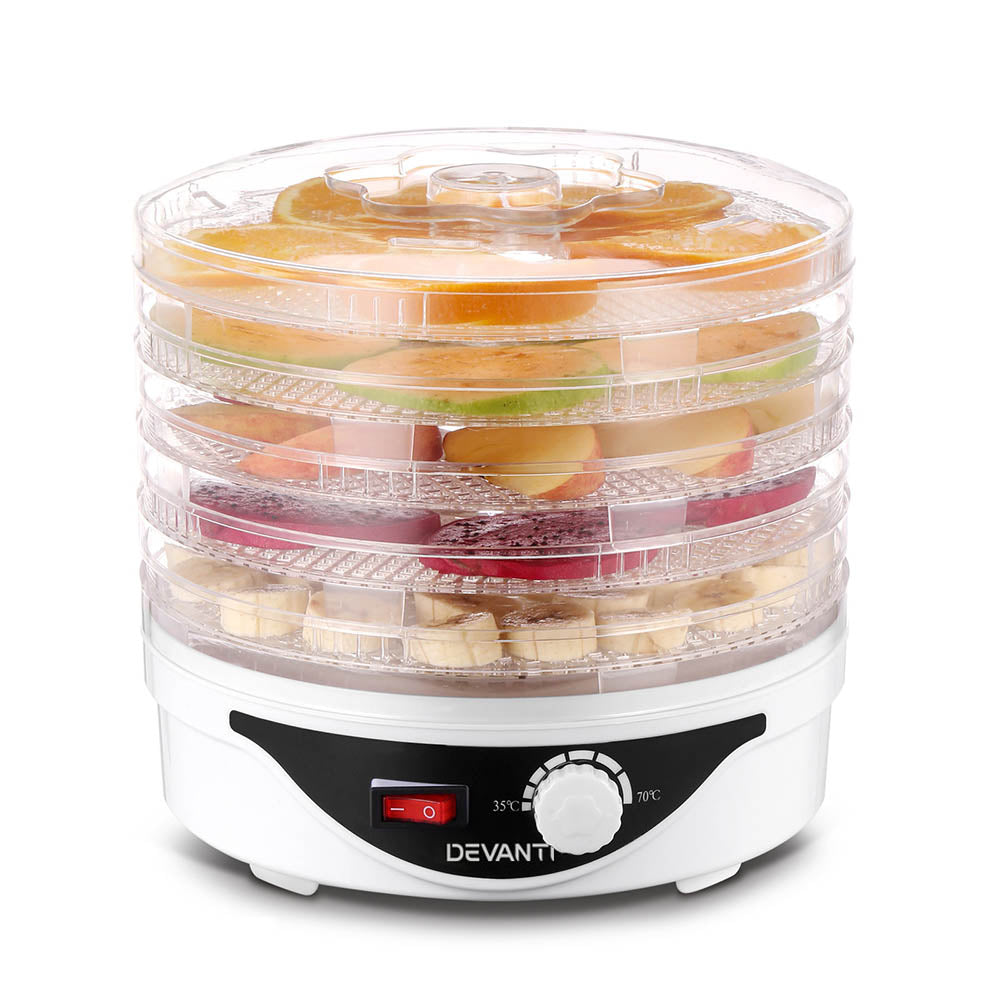 Electric food dehydrator with adjustable temperature dial drying sliced fruits on stackable trays