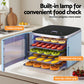 Food dehydrator with visible window and multiple trays drying sliced fruit in a kitchen