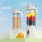 White portable blender juicer with digital display, whole fruits, and juice, outdoors with orange